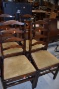 A set of four vintage stained frame ladder back chairs
