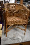 A small wicker work chair, child or dolls size, width approx. 33cm