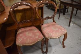 A pair of mahogany balloon back dining chairs, repair to backs