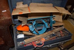 A toolbox and contents including Black and Decker power saw parts