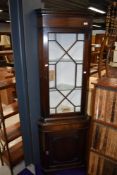 A traditional mahogany corner display cabinet
