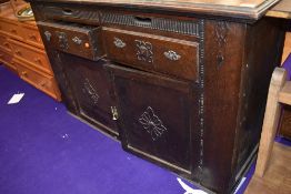 An early 20th Century oak sideboard , having interesting frieze drawers and additional 'wings' ,