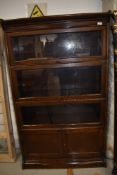 A Globe Wernicke style sectional bookcase of four tiers including cupboard base , width approx. 87cm
