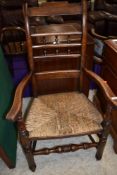 A traditional stained frame, Lancashire or similar spindle back carver chair having rush seat