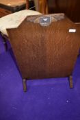 An early 20th Century oak fire screen