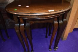An early 20th Century mahogany nest of three oval tables