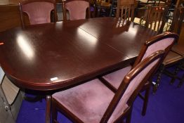 A modern mahogany effect reproduction Regency style dining table and four chairs having