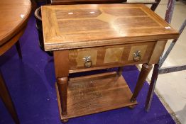 A modern hardwood side table, having deep frieze drawer, lined with script referring to Mr Baker's