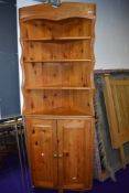A vintage pine corner sehelf with cupboard under