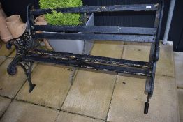 A traditional cast garden bench, wooden slats in disrepair