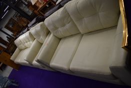 A modern cream leather lounge suite comprising two settees (approx widths 244 and 174cm) and an