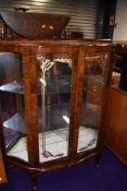 A mid 20th Century dark walnut bow fronted display cabinet, width approx. 104cm