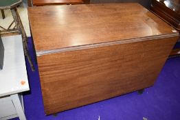 An early 20th century drop leaf mahogany dining table
