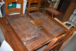 A modern stained frame extending dining table and four similar ladderback chairs