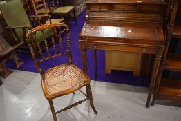 A reproduction hardwood ladies desk havong demi roll top, and similar cane seated chair, width