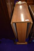 A laminate gateleg kitchen table of narrow proportions
