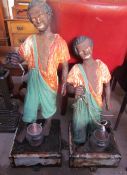 A pair of cast iron blackamoor type figures