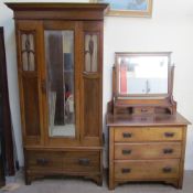 An Edwardian walnut two piece bedroom suite comprising a single door wardrobe and matching dressing