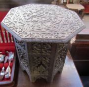 An Anglo Indian hardwood occasional table with an octagonal top and base carved with flowers and