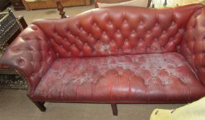 A red leatherette three piece suite with button back upholstery on square legs