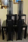 A black glass extending dining table and six chairs