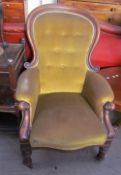 A Victorian mahogany framed spoon back library chair on turned legs and casters