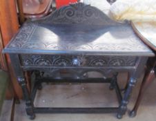 A 19th century ebonised low countries side table with a single drawer and lions mask handle on