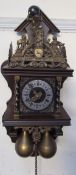 A Dutch wall clock with a cast brass decoration and brass weights