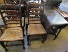 An oak gate leg dining table and four ladder back chairs