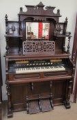 A Mason & Hamlin harmonium, with a central rectangular mirror and shelves