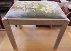 A dressing table stool, the pad seat embroidered with daffodils by Angela Dewar embroidery