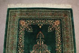 A Stunning Persian emerald green silk Qum carpet