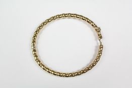 A 9ct yellow gold bangle