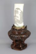 A Japanese Meiji Era (1868-1912) Tusk Vase. The vase elaborately carved with a realistic monkey