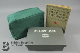 A Vintage American Red Cross First Aid Textbook and Metal First Aid Kit