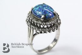 A White Metal and Synthetic Black Opal Ring