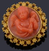 An Etruscan style carved coral cherub brooch