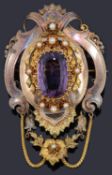 A large Continental 19th Century amethyst set scroll pendant brooch