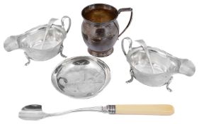 A pair of George V silver sauce boats and ladles, a christening mug and a dish