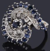A decorative white gold sapphire and diamond stylised crossover ring