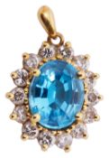 A delicate gold blue topaz and diamond pendant