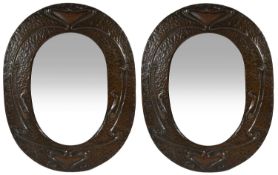 A pair of Arts and Crafts oval hammered copper wall mirrors