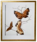 A contemporary wooden picture of three butterflies on a branch
