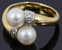 A decorative 18ct gold pearl and diamond crossover ring