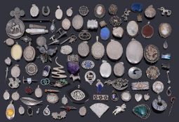 A large collection of silver brooches, pendants and lockets