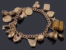 A 9ct gold charm bracelet with padlock and assorted gold charms