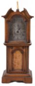 A late 19th century continental walnut miniature longcase mantle clock