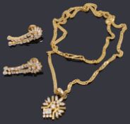 An Indian high carat gold pendant on chain and similar earrings