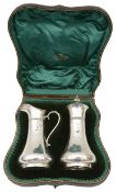 An Edward VII cased silver sugar caster and matching cream jug