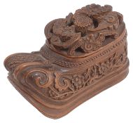 A 19th century Chinese Qing dynasty carved coquilla nut shoe shaped snuff box